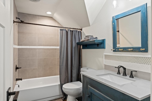 full bathroom with vanity, vaulted ceiling, toilet, and shower / tub combo with curtain