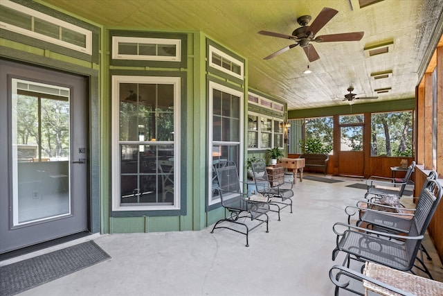 sunroom / solarium featuring ceiling fan and wood ceiling