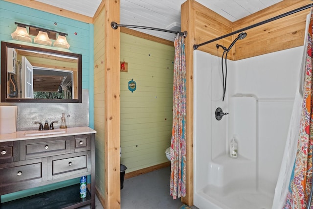 bathroom with vanity, curtained shower, toilet, and wooden walls