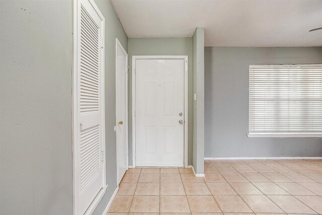 foyer entrance with light tile patterned floors