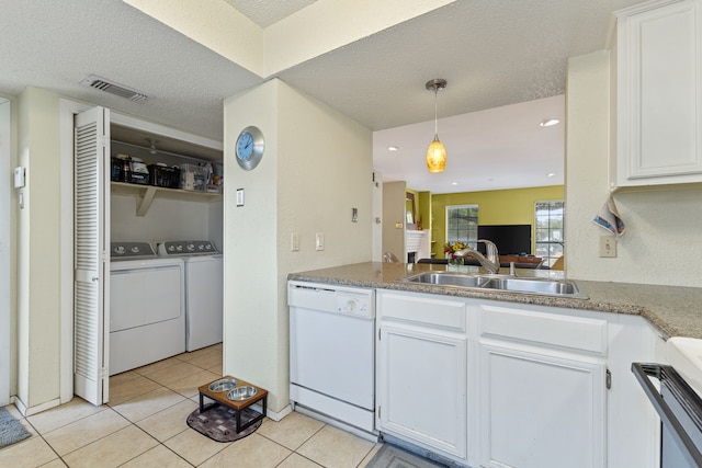 kitchen with sink, hanging light fixtures, white dishwasher, white cabinets, and light tile patterned flooring