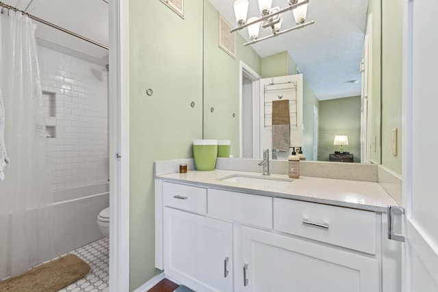 full bathroom with shower / tub combo with curtain, vanity, toilet, tile patterned floors, and a textured ceiling