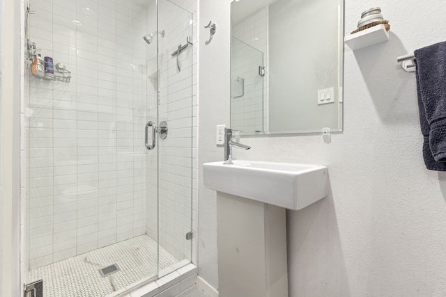 bathroom featuring a shower with shower door