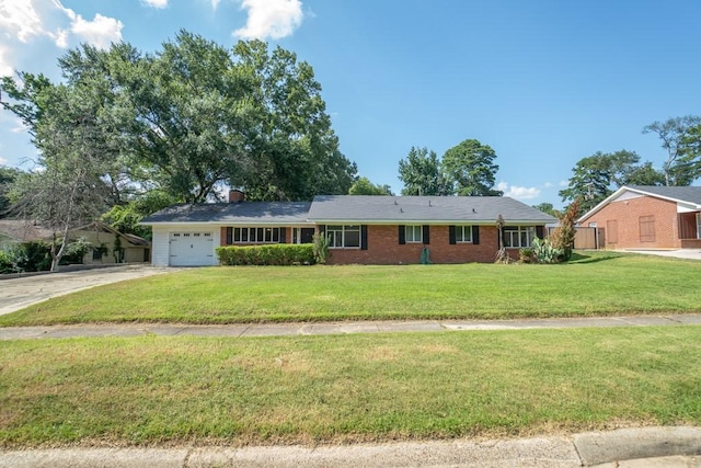 ranch-style home featuring a garage and a front lawn