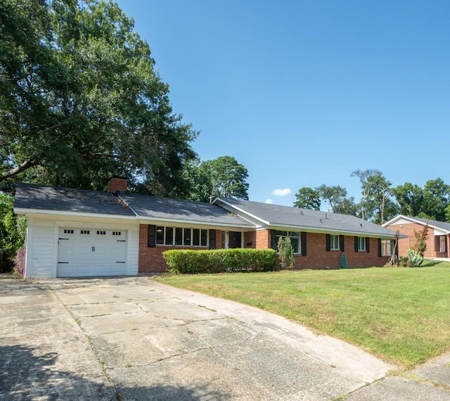 single story home featuring a front yard and a garage