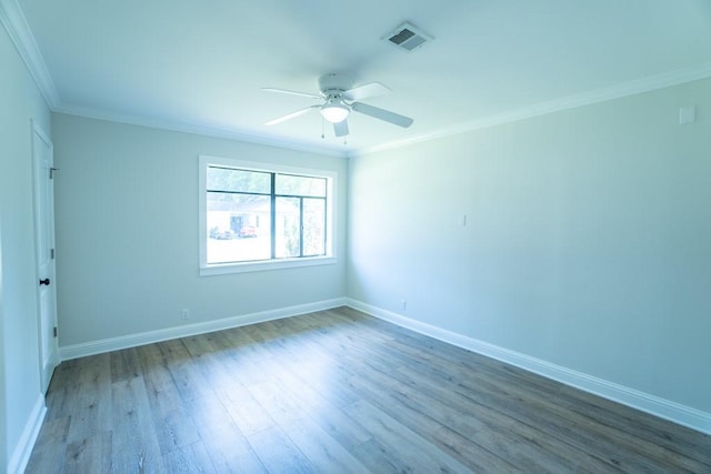 empty room featuring crown molding, hardwood / wood-style floors, and ceiling fan