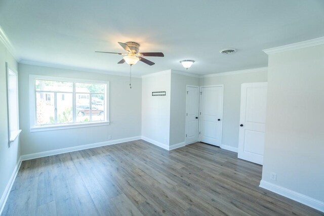 empty room with wood-type flooring, ceiling fan, and ornamental molding