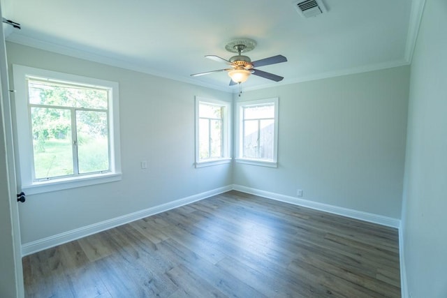 empty room with wood-type flooring, ornamental molding, ceiling fan, and a healthy amount of sunlight