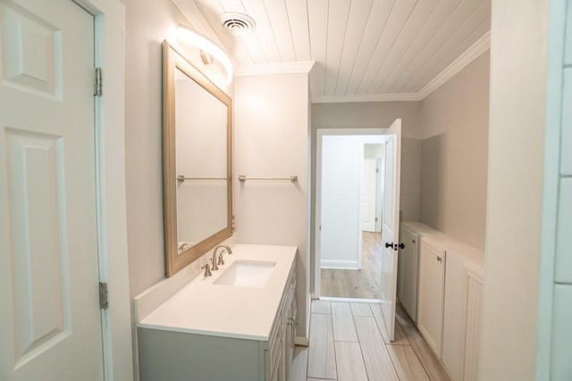 bathroom featuring crown molding, vanity, and wood ceiling