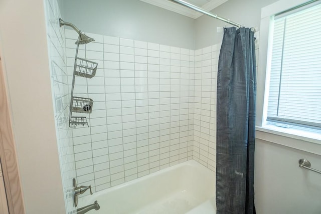 bathroom featuring crown molding, a wealth of natural light, and shower / bath combo with shower curtain