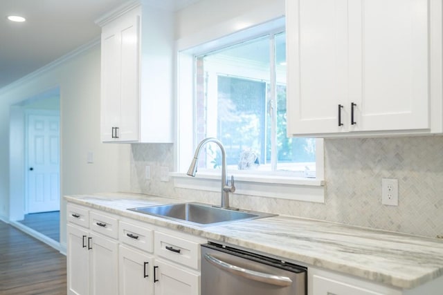 kitchen with backsplash, dishwasher, sink, and white cabinets