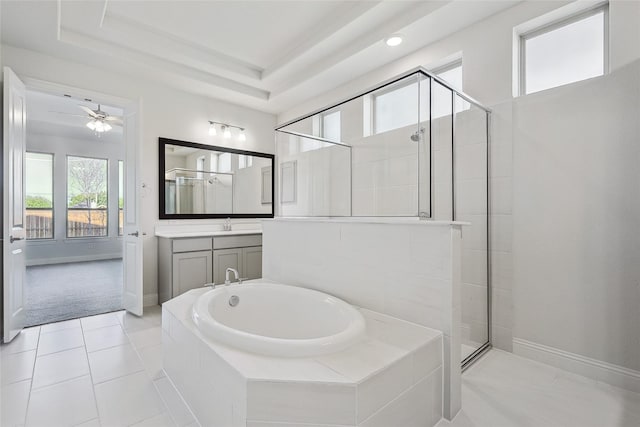 bathroom with separate shower and tub, tile patterned flooring, a tray ceiling, and vanity