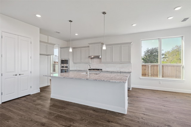 kitchen with stainless steel appliances, light stone countertops, gray cabinetry, and decorative light fixtures