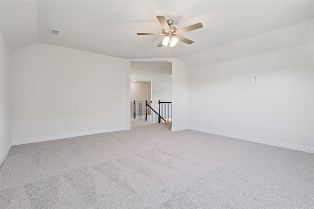 spare room featuring ceiling fan, vaulted ceiling, and carpet