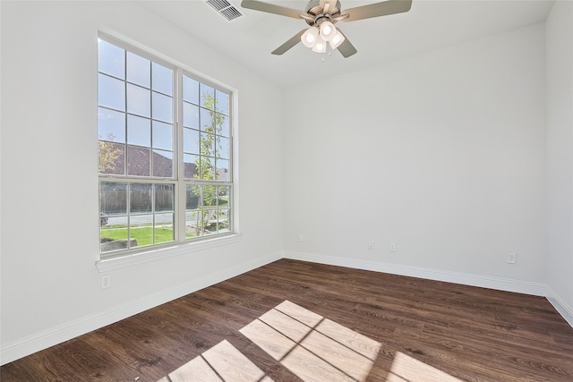 unfurnished room featuring ceiling fan, plenty of natural light, and dark hardwood / wood-style flooring