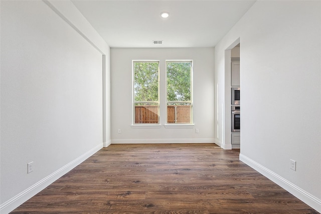 empty room featuring dark hardwood / wood-style flooring