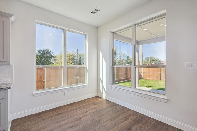 unfurnished room with dark hardwood / wood-style flooring