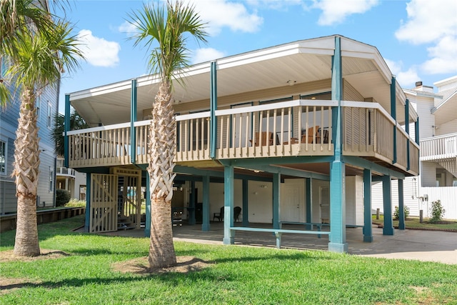 rear view of house featuring a yard and a deck