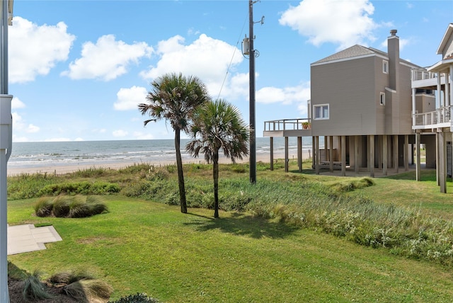 view of yard featuring a water view and a view of the beach