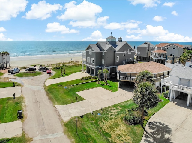 birds eye view of property featuring a beach view and a water view