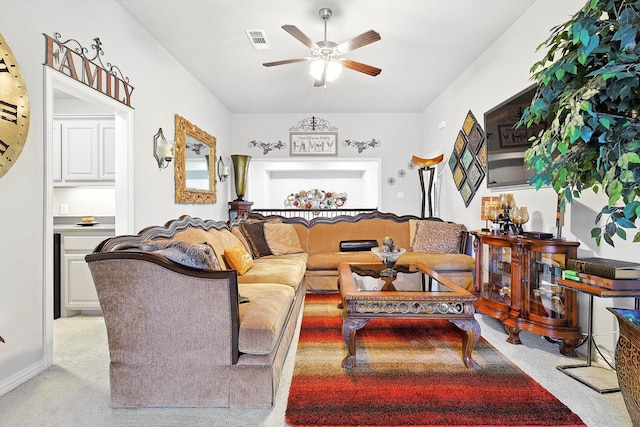 living room featuring ceiling fan and light colored carpet