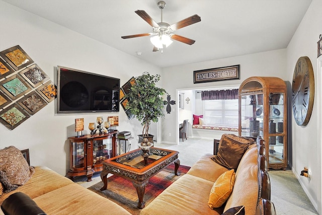 carpeted living room with ceiling fan