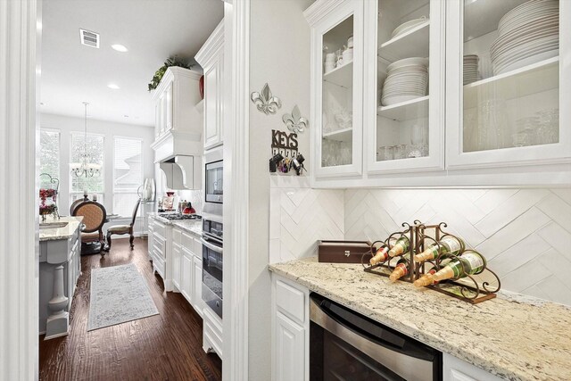 kitchen featuring pendant lighting, backsplash, white cabinets, and wine cooler