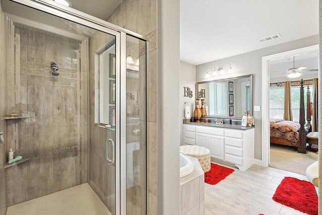 bathroom with ceiling fan, wood-type flooring, vanity, and shower with separate bathtub