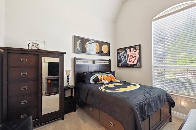 carpeted bedroom with lofted ceiling