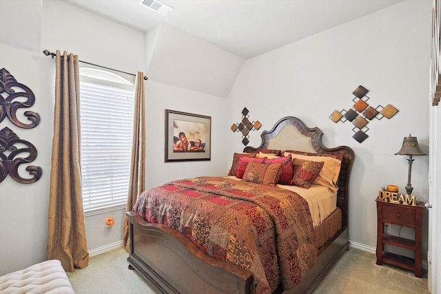 bedroom with lofted ceiling and light colored carpet