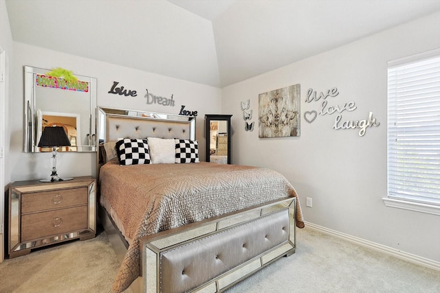 bedroom with light colored carpet and vaulted ceiling