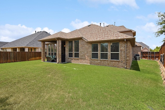 back of house featuring central air condition unit, outdoor lounge area, and a lawn