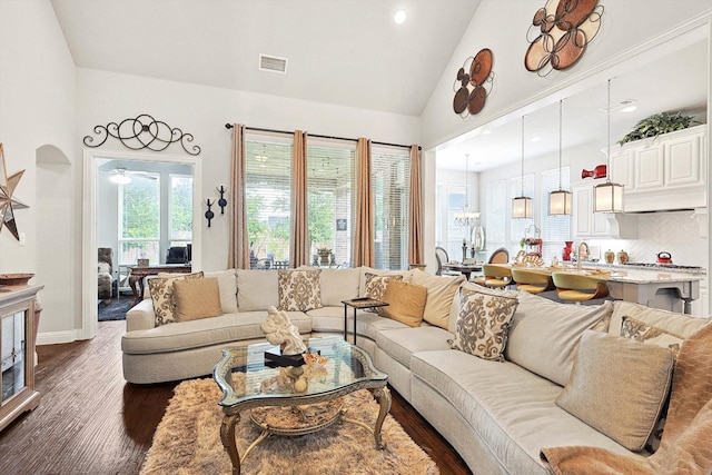 living room with ceiling fan, sink, dark hardwood / wood-style floors, and high vaulted ceiling