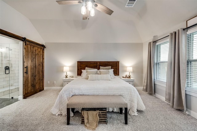 carpeted bedroom with ceiling fan, ensuite bathroom, lofted ceiling, and a barn door