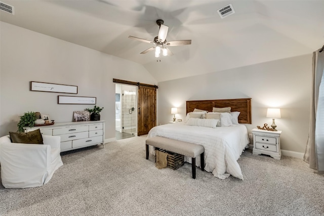 carpeted bedroom with ceiling fan, lofted ceiling, connected bathroom, and a barn door