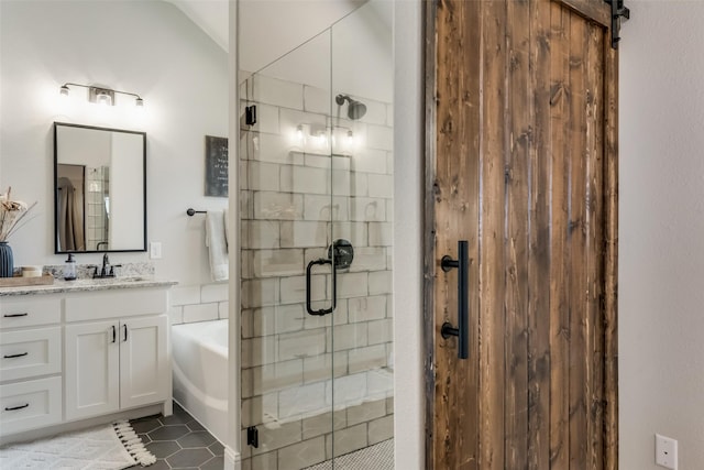 bathroom featuring tile patterned floors, vanity, independent shower and bath, and vaulted ceiling