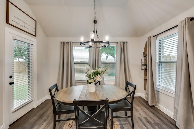 dining room with a healthy amount of sunlight, dark hardwood / wood-style flooring, and lofted ceiling