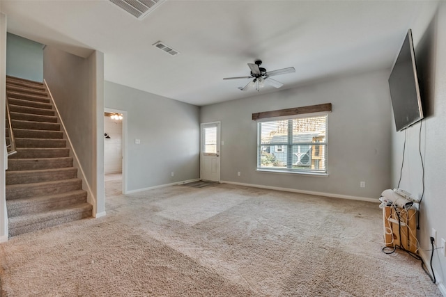 unfurnished living room featuring carpet flooring and ceiling fan