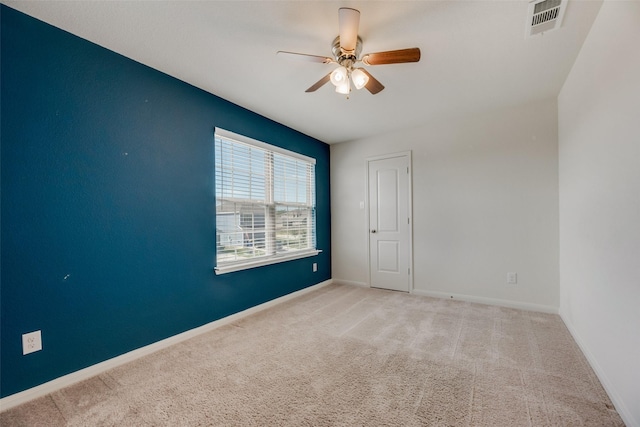 empty room with ceiling fan and light colored carpet