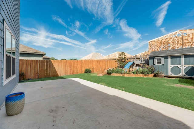 view of yard with a patio area and a storage shed