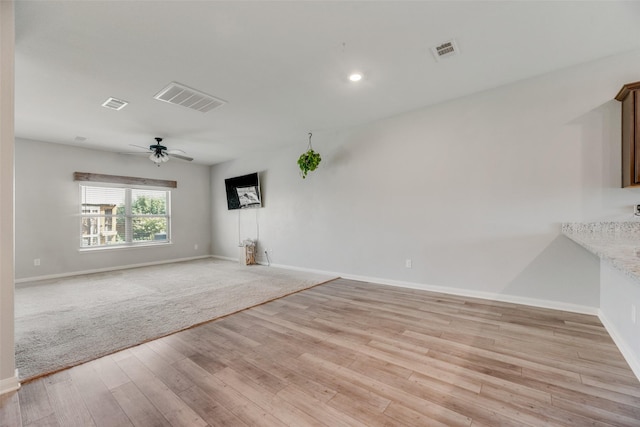 unfurnished living room with ceiling fan and light wood-type flooring