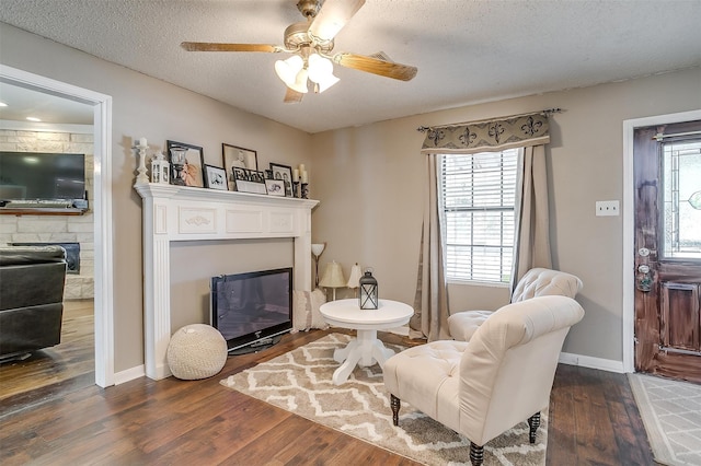 interior space featuring dark wood-type flooring, a textured ceiling, and ceiling fan