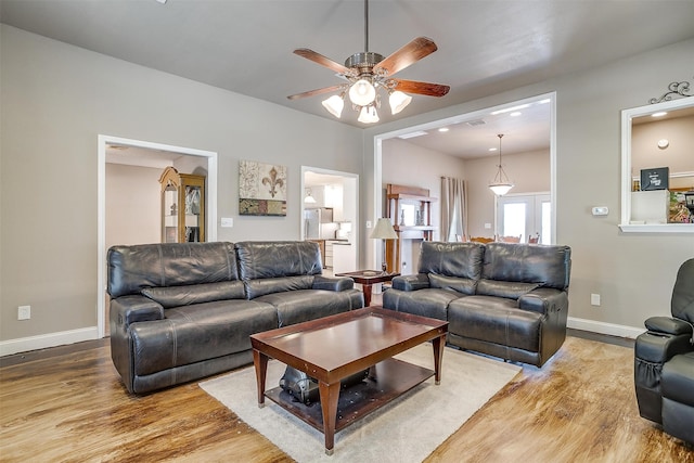 living room with hardwood / wood-style flooring and ceiling fan