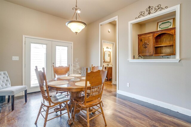 dining space featuring french doors, wood-type flooring, and a wealth of natural light