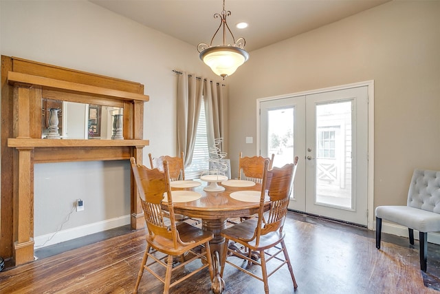 dining space with dark hardwood / wood-style flooring and french doors