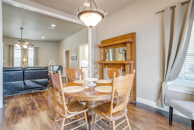 dining room with wood-type flooring and ceiling fan