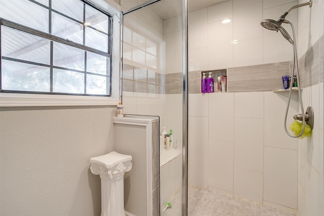 bathroom with a shower with door