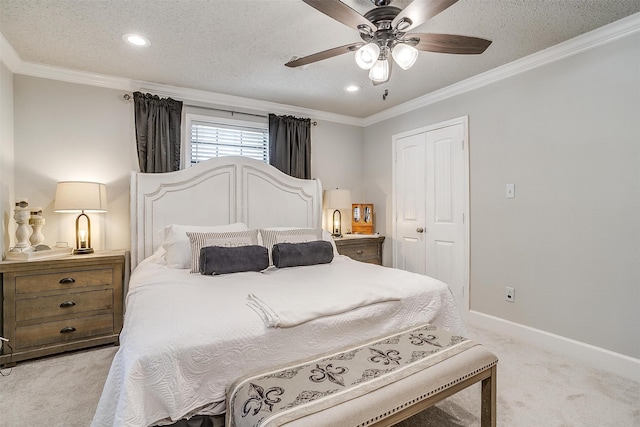 carpeted bedroom featuring ornamental molding, a closet, a textured ceiling, and ceiling fan