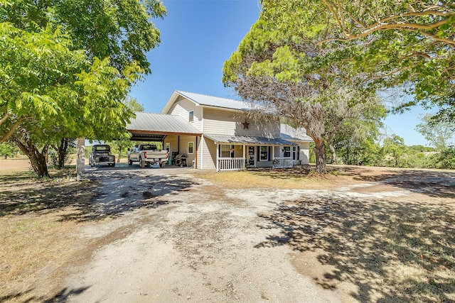 view of front of house featuring a carport and a porch