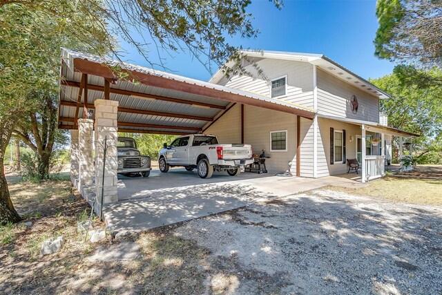 exterior space featuring a carport and a porch